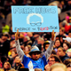 This file photo taken March 25, 2016, shows Devonte Hart holding up a sign as Democratic presidential candidate Bernie Sanders addressed the crowd during a rally at the Moda Center in Portland, Ore.